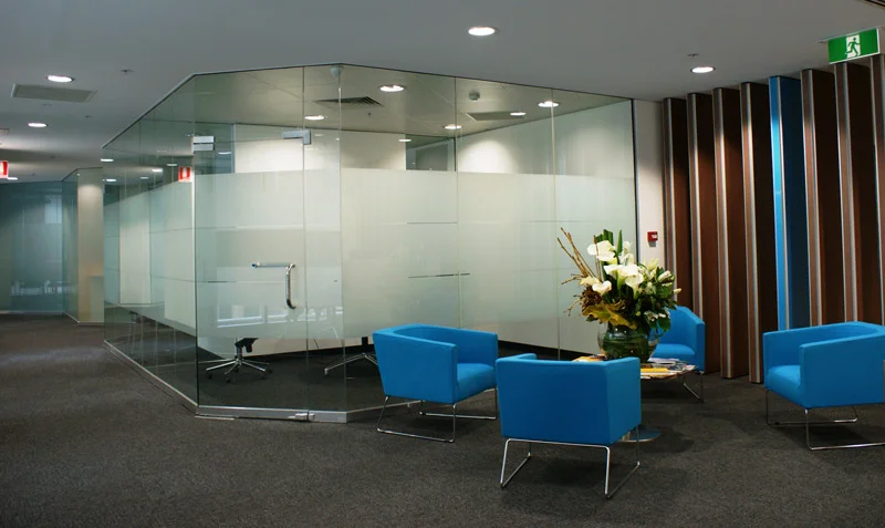 Clear internal glass walls dividing a commercial workspace