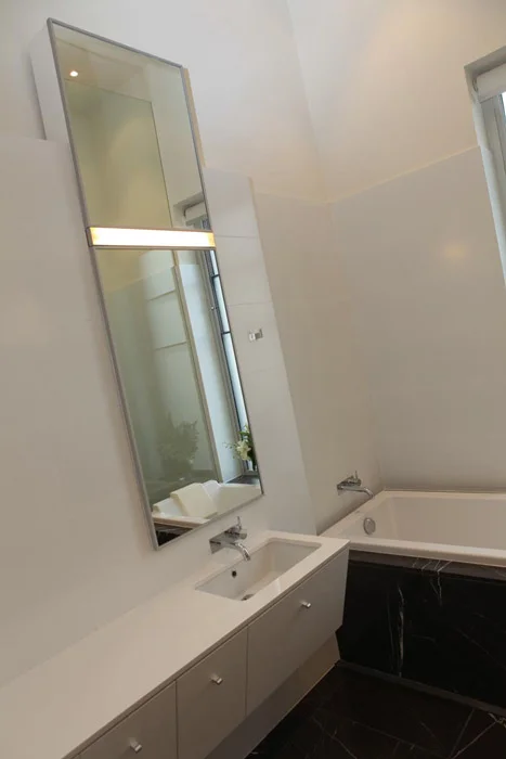 Custom bevelled mirror adding depth and reflected detail to an interior