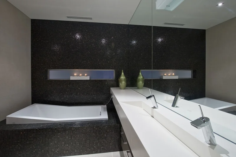 Large custom wall mirror fitted in a contemporary bathroom
