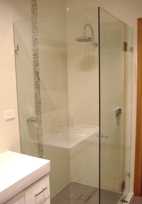 Open bathroom with a custom glass shower enclosure