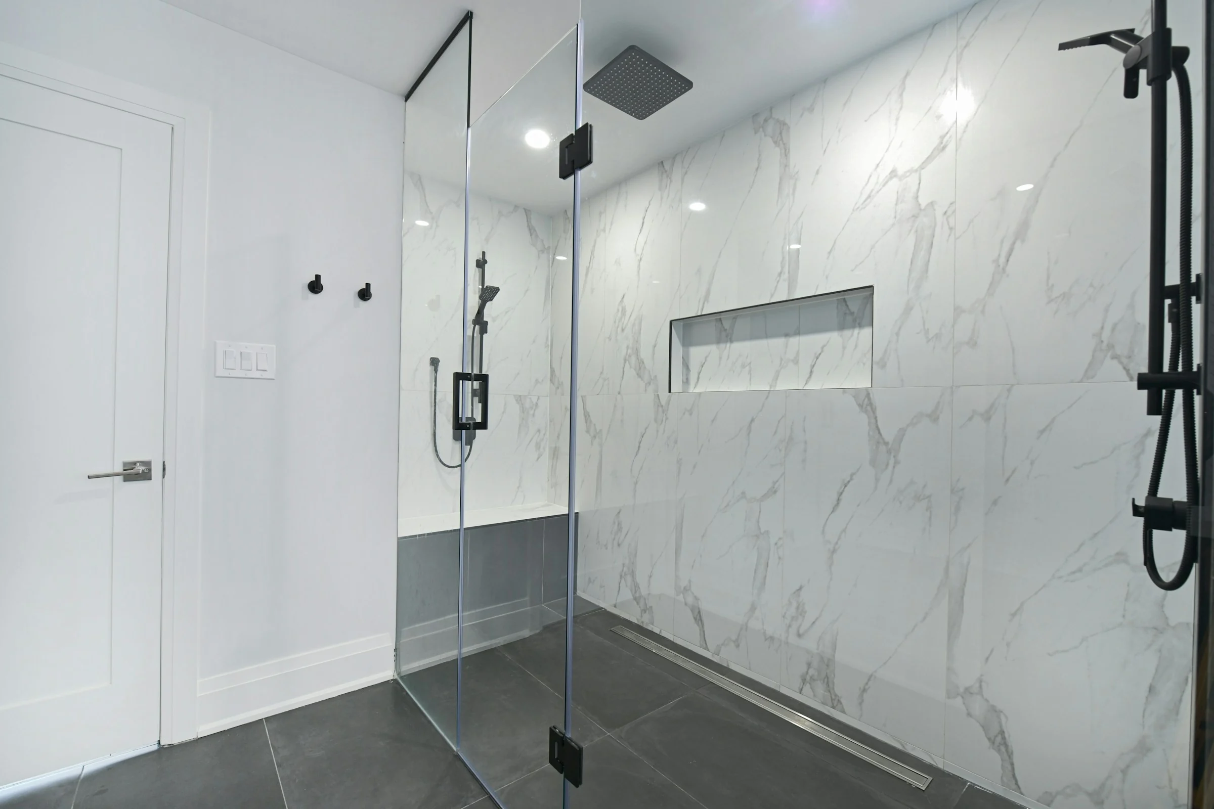 Bright residential bathroom with a frameless glass shower enclosure