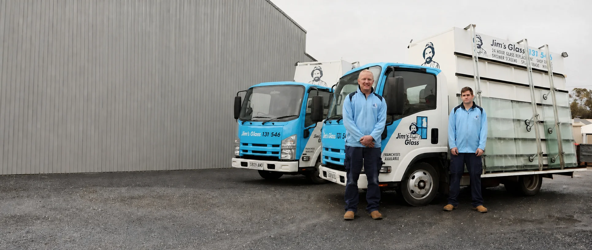 Jim's Glass professionals with branded service vehicles
