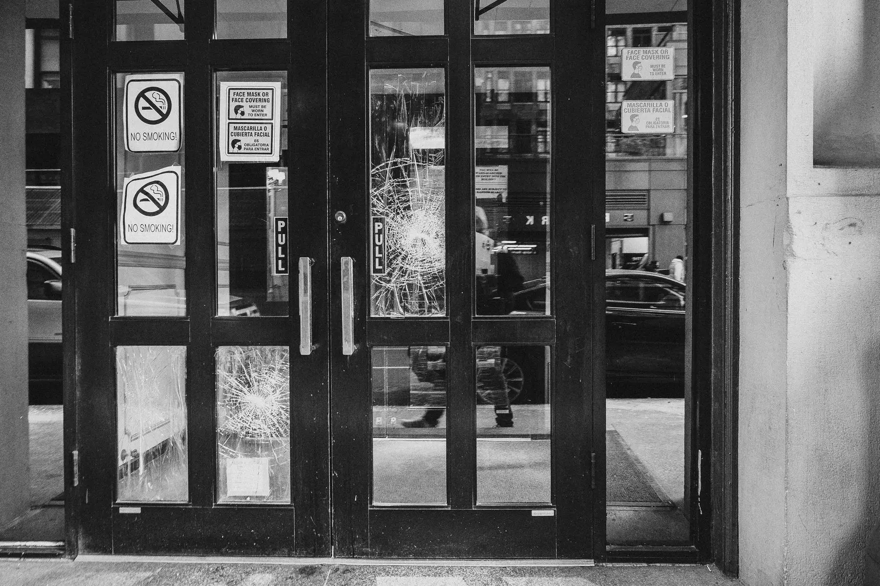 Cracked commercial glass doors requiring replacement