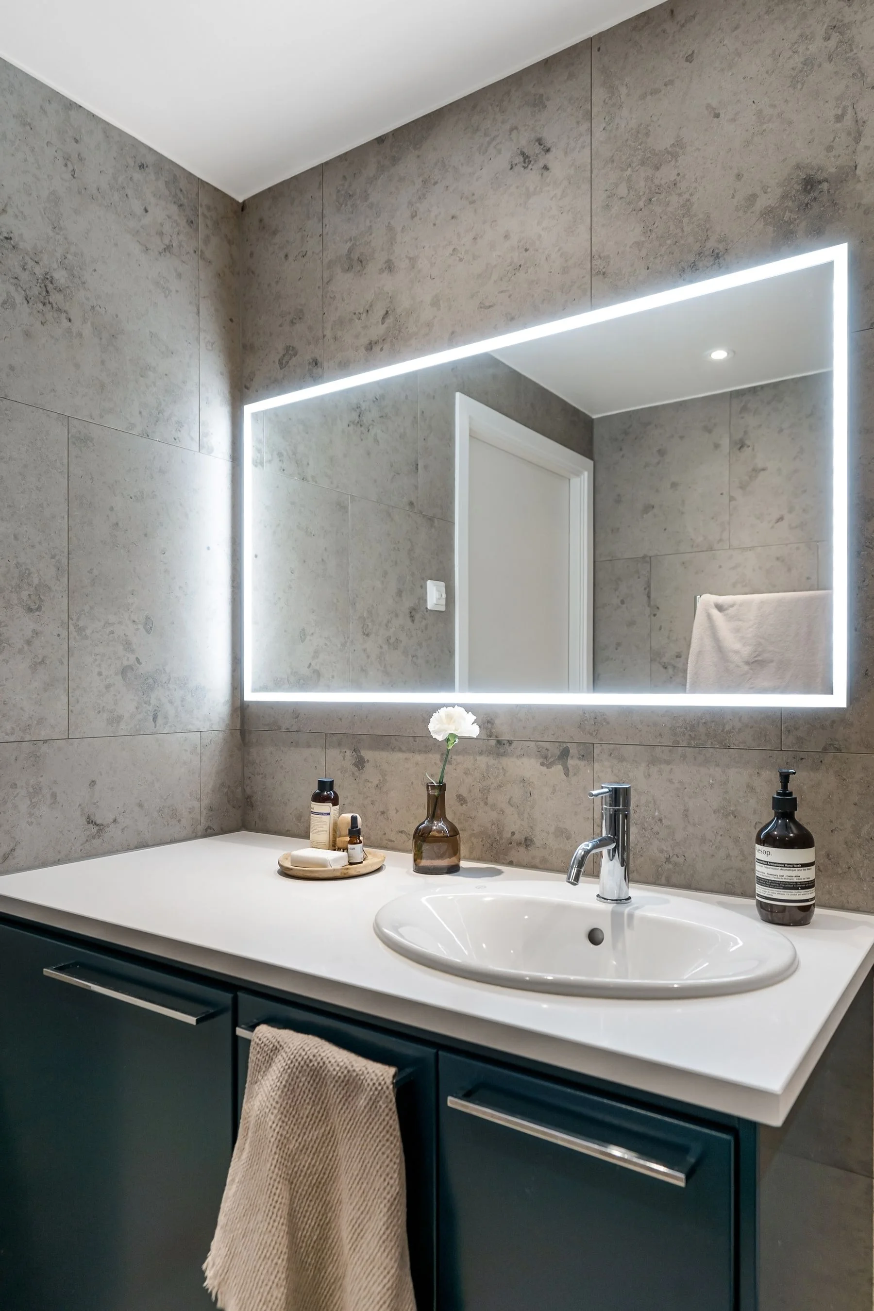 Modern bathroom with an illuminated wall mirror