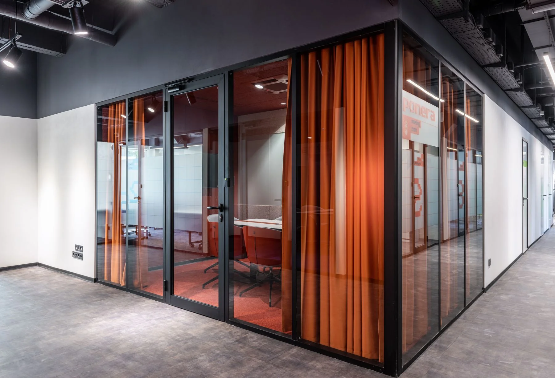 Office conference room enclosed by glass partitions