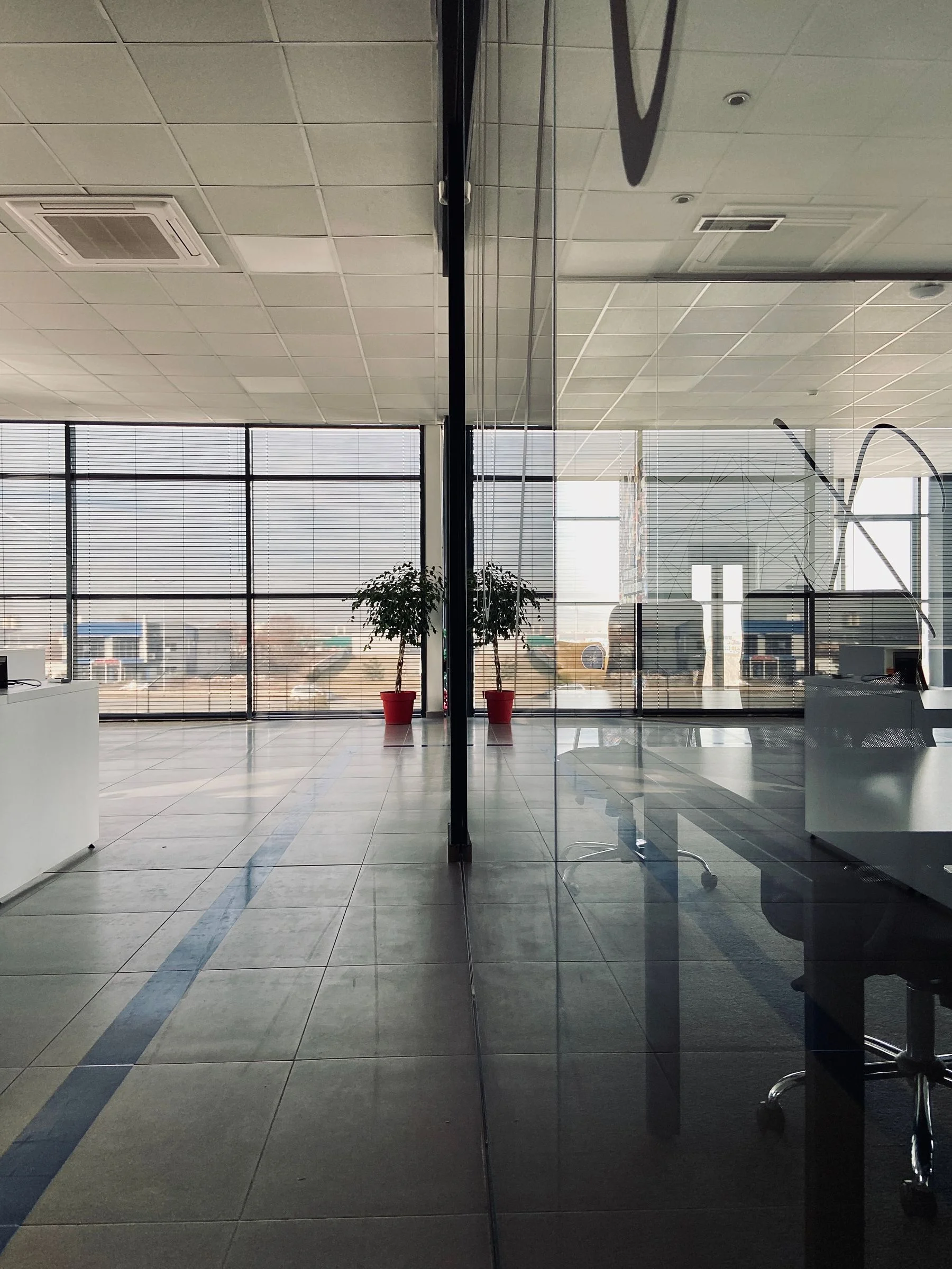 Modern office divided by full-height glass walls